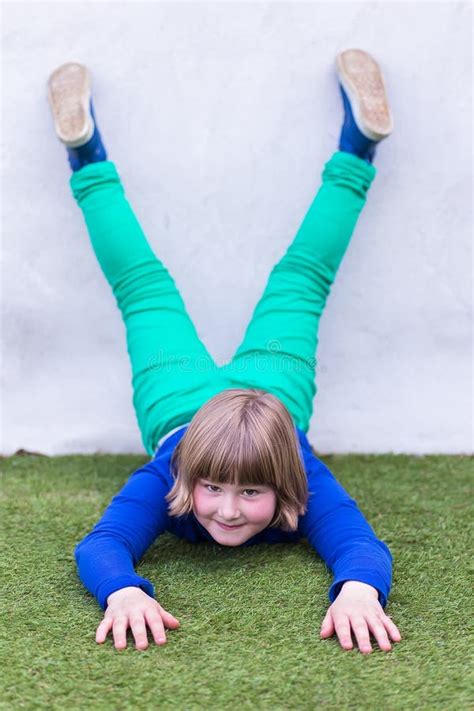Young Girl Lying Upside Down Against Wall Stock Photos Free And Royalty