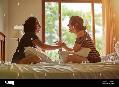 Two Laughing Womans In Bedroom Talking About Stock Photo Alamy