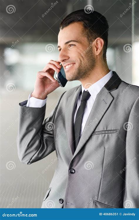 Attractive Young Businessman On The Phone In An Office Building Stock