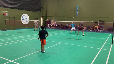 Formal games are played on a rectangular indoor court. Kids double play badminton against men - YouTube
