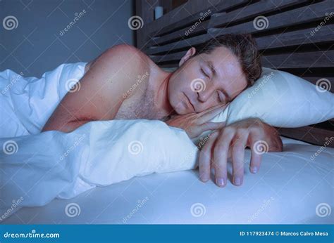 Young Attractive And Handsome Tired Man On His 30s Or 40s In Bed Sleeping Shirtless Peacefully