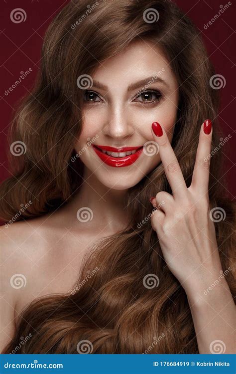 Beautiful Girl With A Classic Make Up Curls Hair And Red Nails
