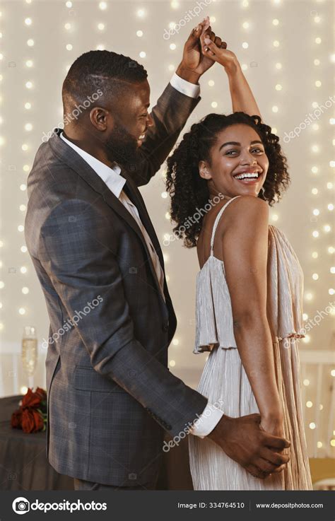 Portrait Of Beautiful Black Couple Dancing In Modern Restaurant Stock