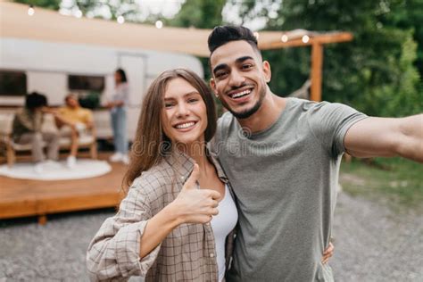 Loving Young Multiracial Couple Taking Selfie Near Motorhome Resting