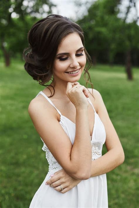 beautiful and sensual brunette model girl in short white dress with closed eyes with stylish