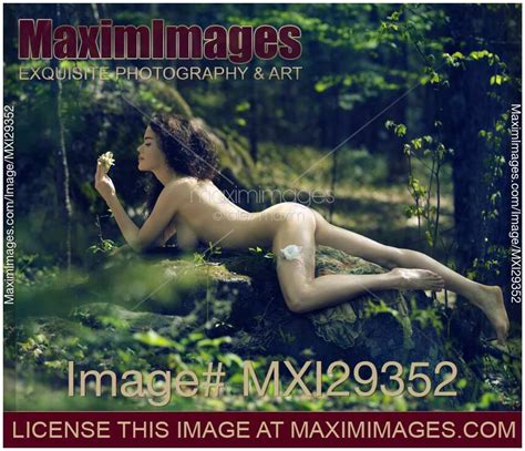 Photo Of Beautiful Nude Woman Lying On Rocks In The Nature Bathing