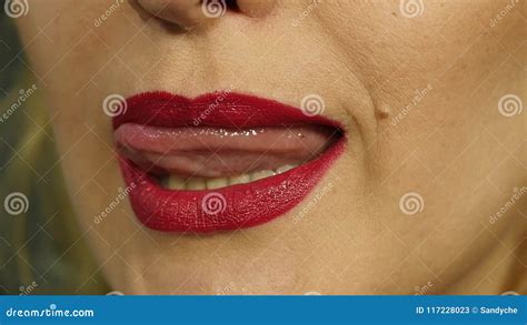 Extreme Close Up Of Lip Woman Pursing Her Lips In A Seductive Gesture