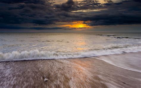 Dark Clouds And Sunset Over Ocean