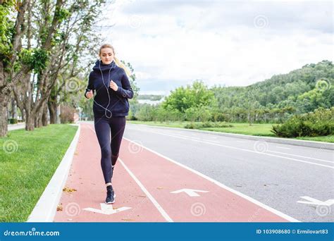 Athletic Woman Running Outdoors Action And Healthy Lifestyle Concept