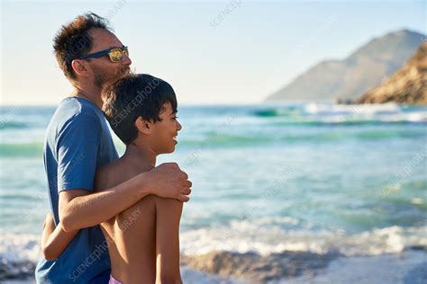 Affectionate Father And Son Hugging On Ocean Beach Stock Image F032