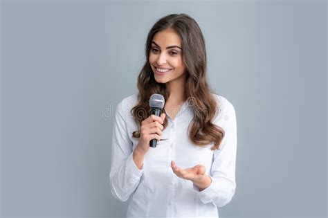 beautiful business woman is speaking on conference happy smiling business woman holding mic