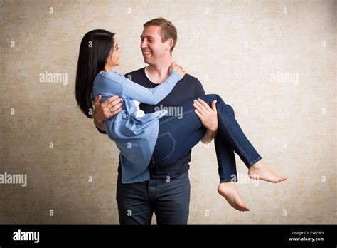 Man Carrying Woman In His Arms Stock Photo Royalty Free Image