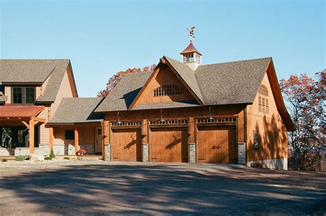 A Large Wooden Building With Two Garages On Each Side