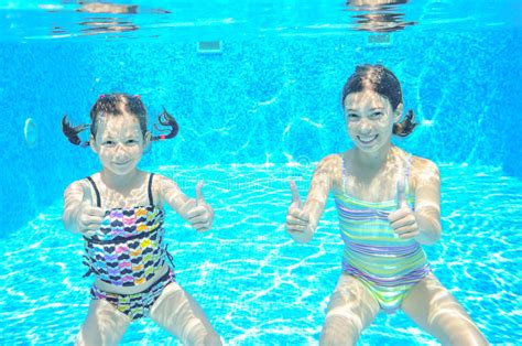 Two Girls Underwater In Swimming Pool Stock Photo Image Of Portrait