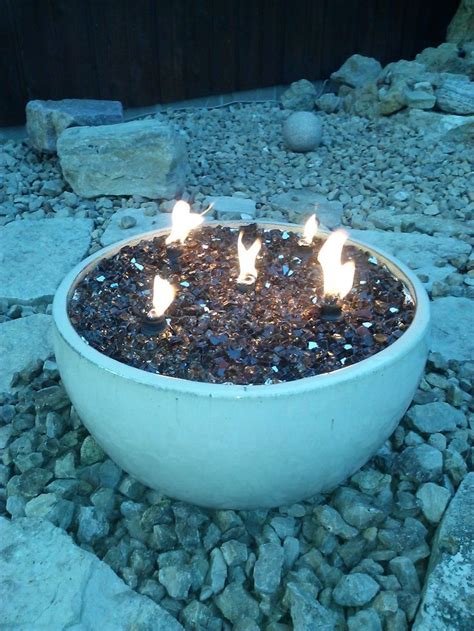 A Fire Pit In A Pot Using Reflective Glass Pieces And Small Tiki