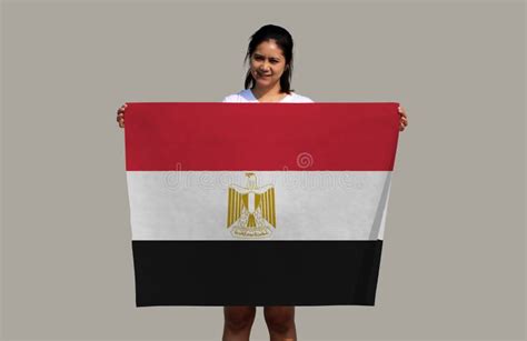 Pretty Lady Holding Egypt Flag In Her Hands On Grey Background Stock