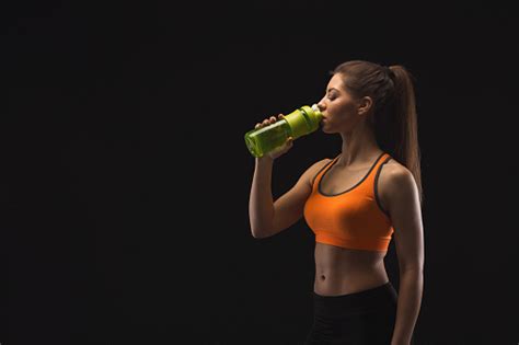 Female Bodybuilder Drinking Water After Workout Stock Photo Download