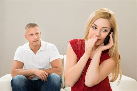 Wife Talking On Mobile Phone While Husband On Sofa Stock Image Image Of Adult Affair 53427399