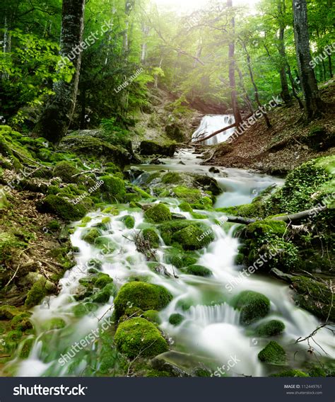 Forest Waterfall And Rocks Covered With Moss Stock Photo 112449761
