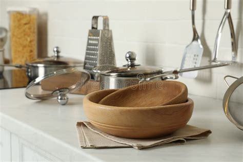 Wooden Bowls And Different Cooking Utensils On Kitchen Counter Stock