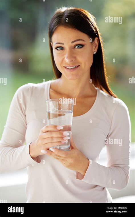 Girl Holding A Glass Of Water Stock Photo Alamy