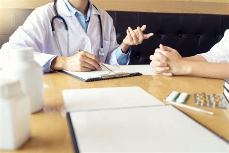 Doctor Explaining Patient Symptoms Or Asking A Question Stock Photo