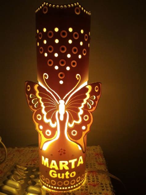 A Lit Up Lamp With A Butterfly On Its Body And The Words Marta Guto