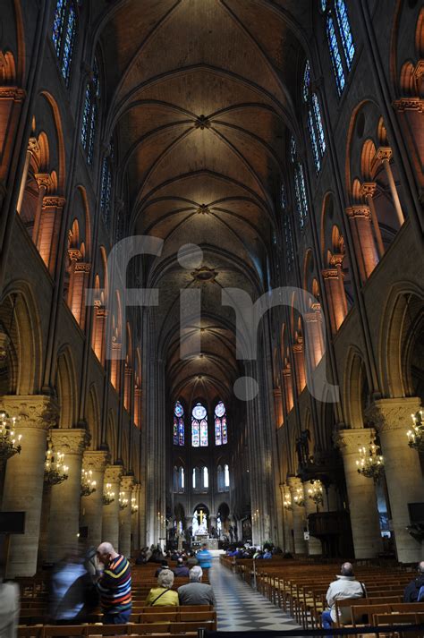 inside of notre dame cathedral in paris looking down the aisle fin
