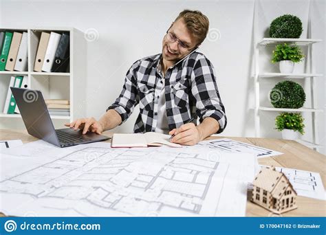 Young Adult Architect And Designer Working In Professional Bureau With