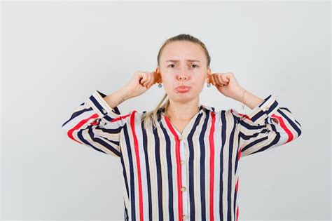 Free Photo Young Woman Pressing Her Hands To Ears And Curving Her