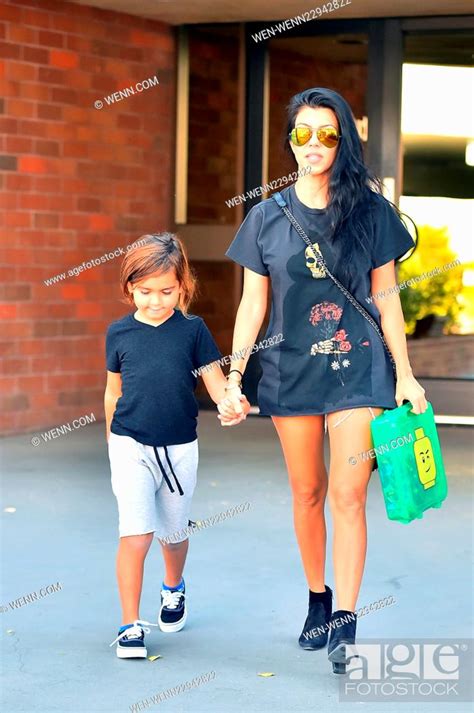 Kourtney Kardashian Wearing A Pair Of Very Short Daisy Duke Cut Offs While Out And Out With Her