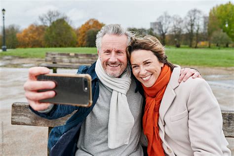 Mature Couple Taking Selfies In A Park By Stocksy Contributor Ivan Gener Stocksy