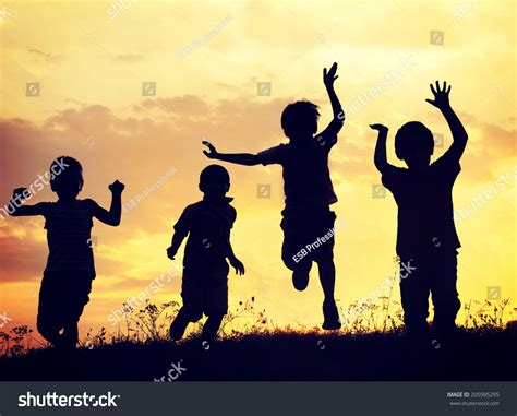 Children Playing On Summer Sunset Meadow Stock Photo 205995295