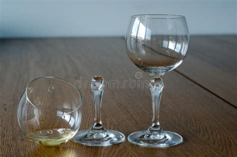 Two Wine Glasses One Half Full Broken Glass And Empty Undamaged Stock