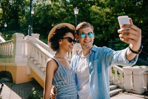 Smiling Interracial Couple In Sunglasses Taking Selfie On Smartphone Stock Image Image Of