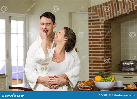 Man Embracing While Woman Feeding Strawberry To Him Stock Image Image