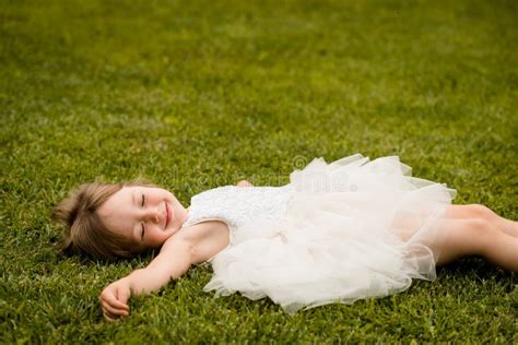 Little Girl Lying On Grass Lawn Smiling Stock Photo Image Of Green