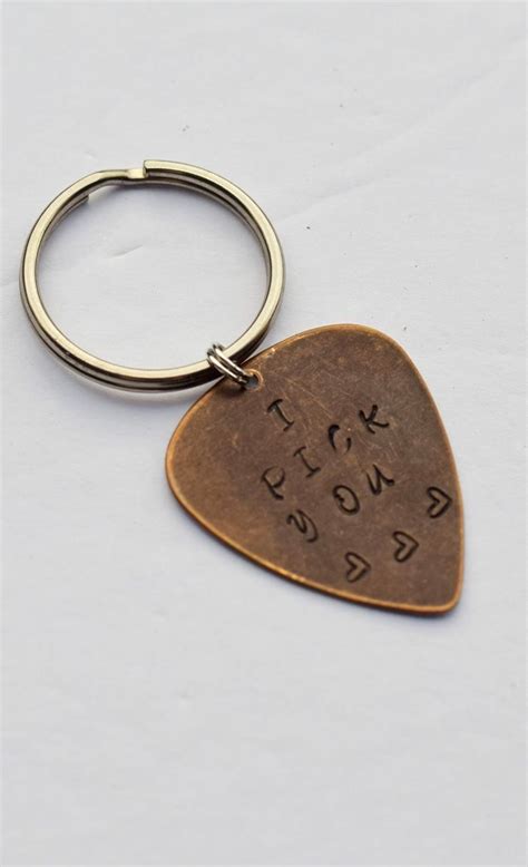 Here's a great little stocking stuffer for the guitar player in your life! DIY Metal Stamped "I Pick You" Guitar Pick on a keychain. Perfect gift idea for the special ...