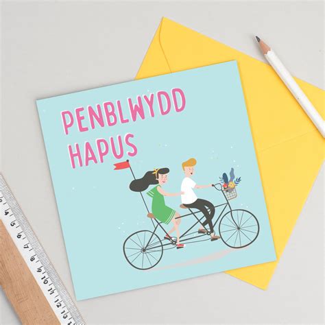 welsh language card birthday card penblwydd hapus featuring a couple on a bike with a choice