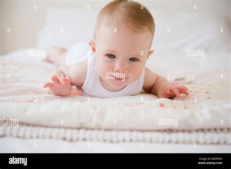 Baby Lying On Bed Stock Photo Alamy