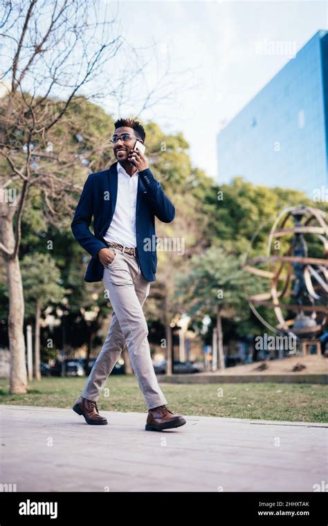 Entrepreneur Stylish Black Man Walking Down The Street While Using His