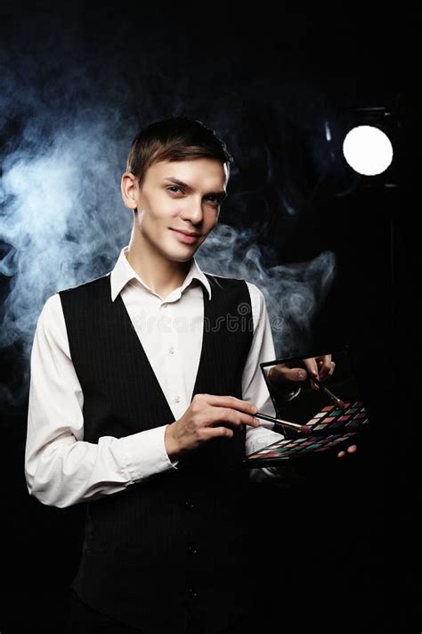 Professional Makeup Artist Posing In Studio Holds A Palette Of Shadows