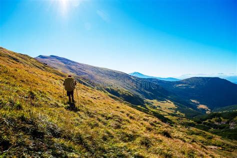 Back View Of Man Backpack Hiking On Green Mountains Stock Photo Image