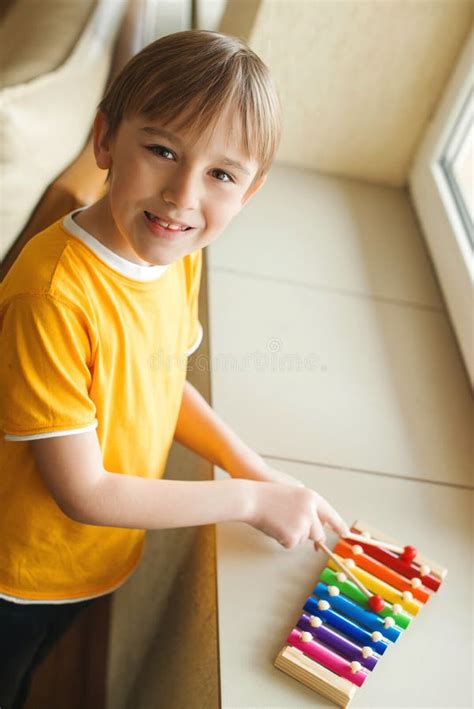 Cute Boy Playing With Xylophone At Home Musical Education And