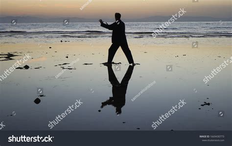 Silhouette Man Practiceing Qigong Exercises Sunset Stock Photo
