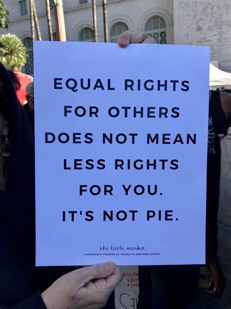 A Woman Holding Up A Sign That Says Equal Rights For Others Does Not