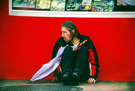 Man Sitting On Sidewalk In Tenderloin District San Francisco