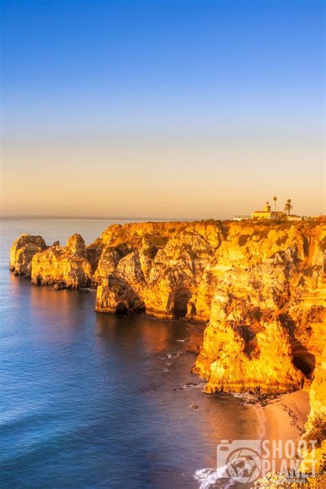 The Ocean And Cliffs At Sunset With Blue Sky