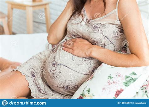 Pregnant Woman Holds Her Hands On Her Swollen Belly Stock Photo Image