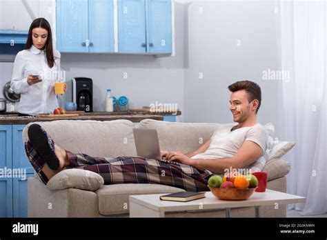 Lazy Husband Having Fun While His Wife Going To Work Stock Photo Alamy